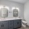well lit bathroom vanity with dual sinks