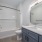 ample lighting in bathroom with shower/tub combo