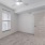 carpeted bedroom with large windows