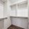 built-in shelving in lighted walk-in closet